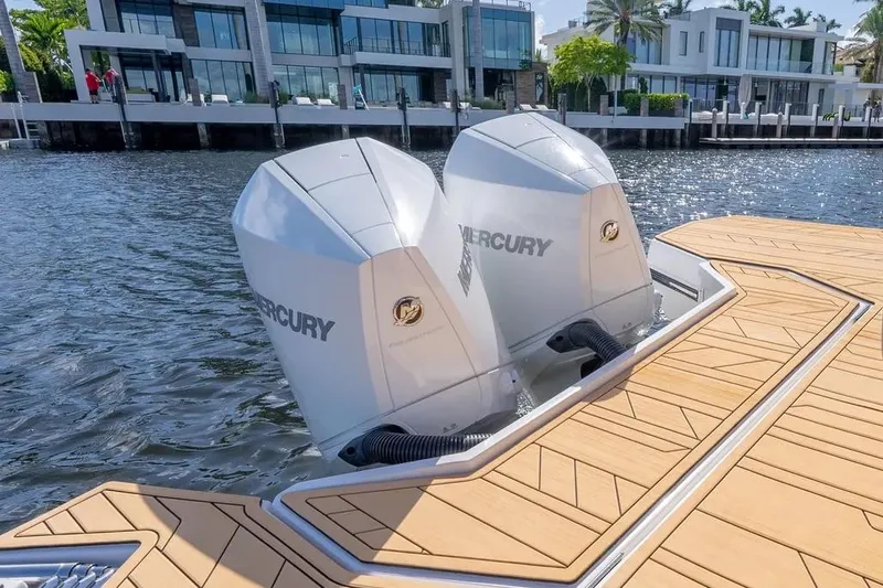  Yacht Photos Pics Luxury boat with dual Mercury engines, Hanover 347 model, 2025, docked by modern waterfront homes.
