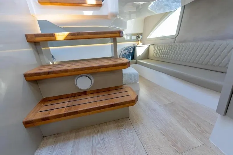  Yacht Photos Pics Luxurious interior of 2025 Hanover 347 yacht with wooden steps and elegant seating.