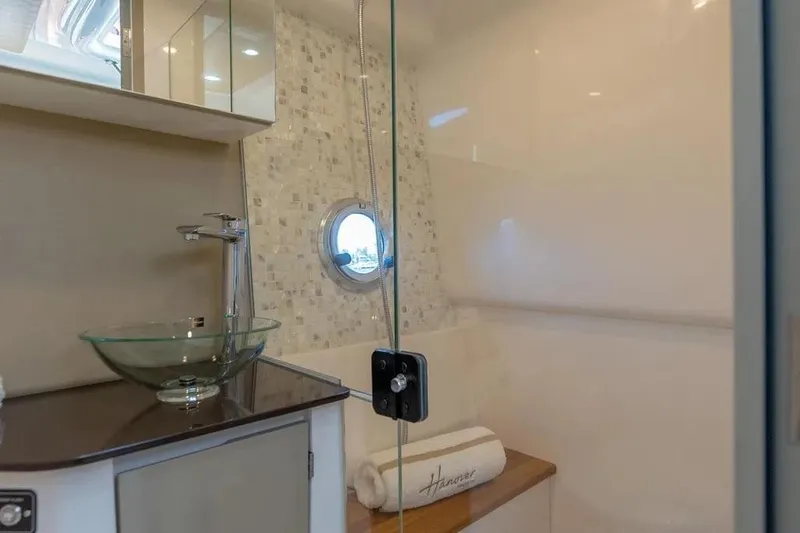  Yacht Photos Pics Luxurious bathroom in 2025 Hanover 347 yacht with glass sink and modern fixtures.