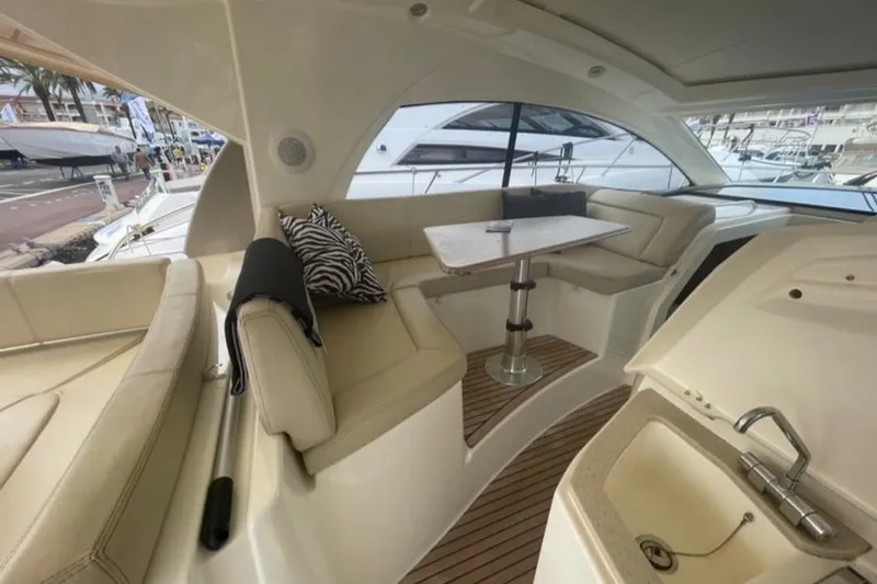  Yacht Photos Pics Luxurious 2009 Prestige 38S yacht interior with seating, table, and sink.