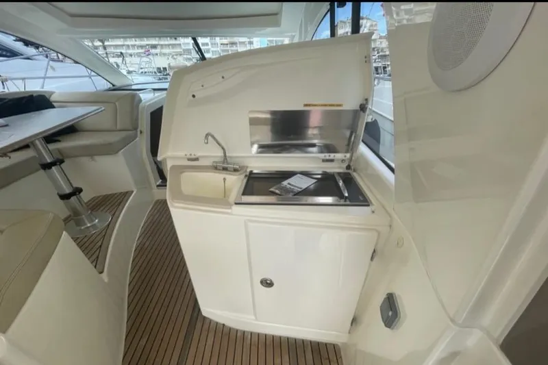  Yacht Photos Pics Interior of 2009 Prestige 38S yacht with kitchenette and seating area.