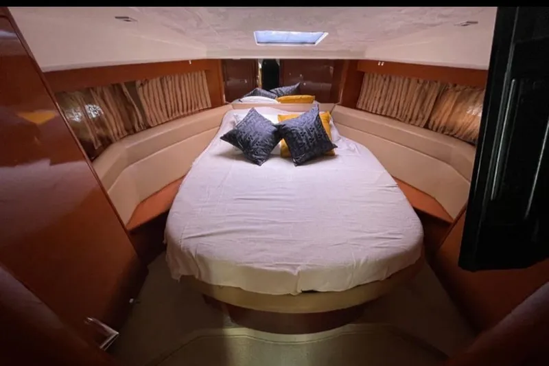  Yacht Photos Pics Luxurious bedroom interior of 2009 Prestige 38S yacht with plush bedding and elegant decor.