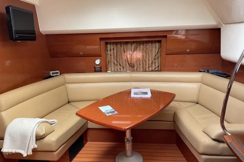  Yacht Photos Pics Luxurious 2009 Prestige 38S yacht interior with beige seating and wooden table.