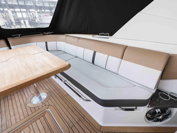  Yacht Photos Pics Luxurious seating area on 2019 Sea Ray SLX 400 yacht with wooden table and elegant upholstery.