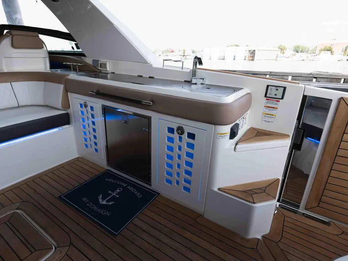  Yacht Photos Pics 2019 Sea Ray SLX 400 yacht interior with kitchenette and seating area.