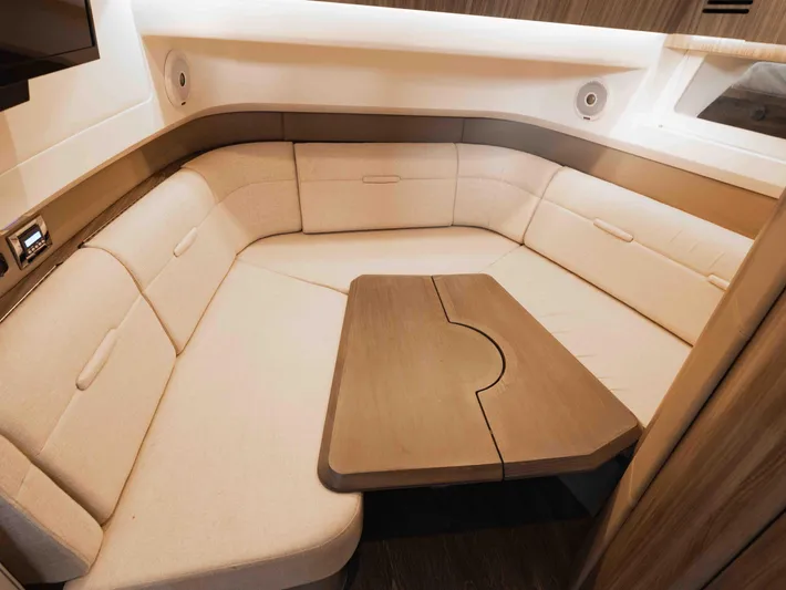  Yacht Photos Pics Luxurious interior of 2019 Sea Ray SLX 400 yacht with plush seating and wooden table.