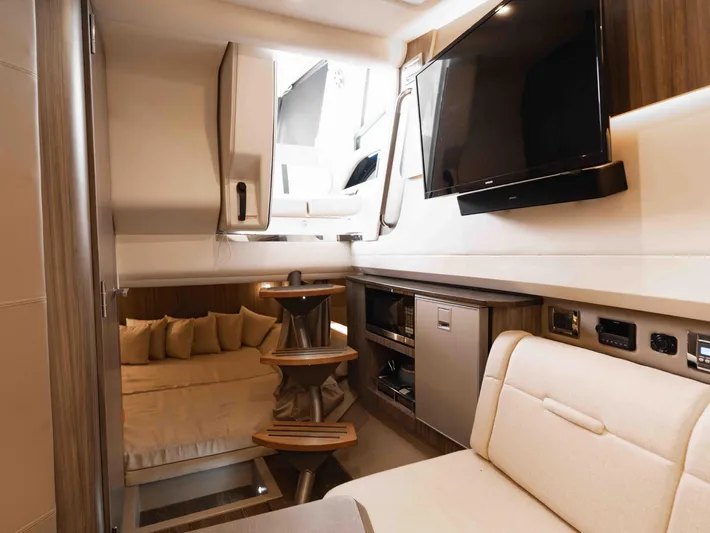  Yacht Photos Pics Luxurious interior of 2019 Sea Ray SLX 400 yacht with modern amenities and cozy seating.