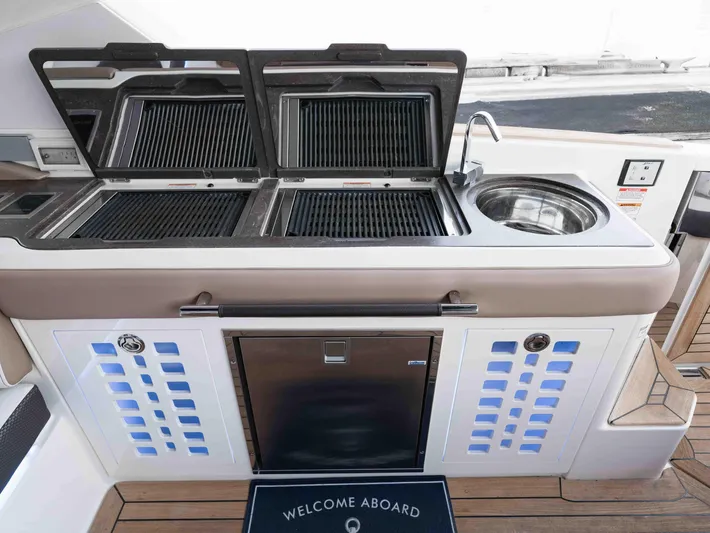  Yacht Photos Pics Outdoor kitchen on 2019 Sea Ray SLX 400 yacht with grill, sink, and fridge.