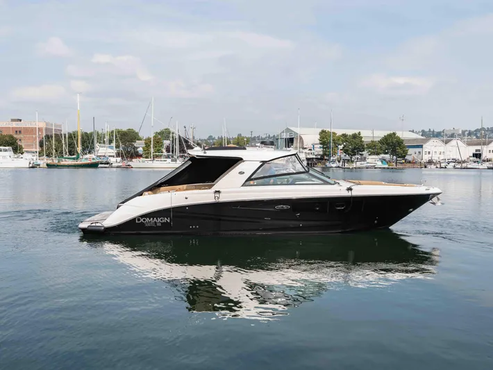  Yacht Photos Pics 2019 Sea Ray SLX 400 yacht docked in a marina, calm waters, clear sky.
