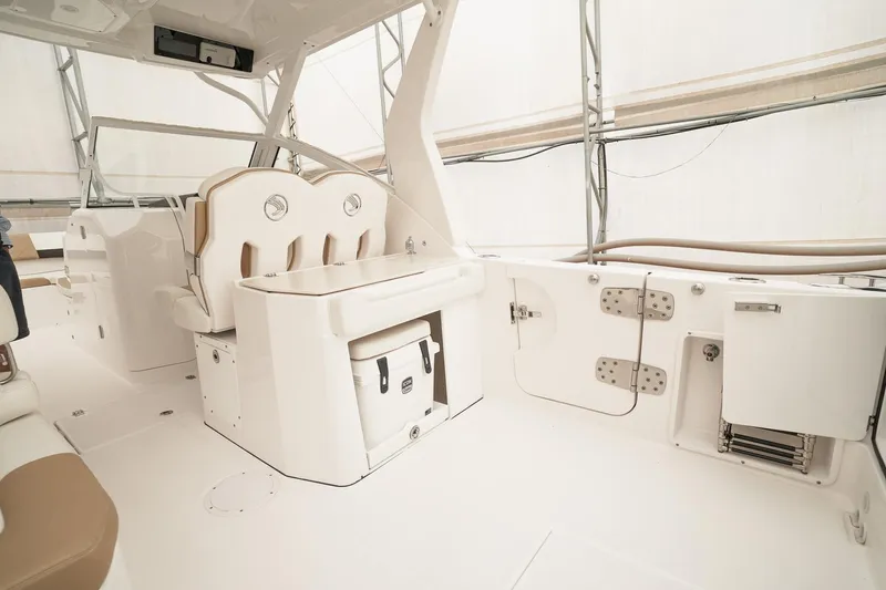  Yacht Photos Pics 2022 Edgewater 262 CX boat interior with seating and storage compartments.