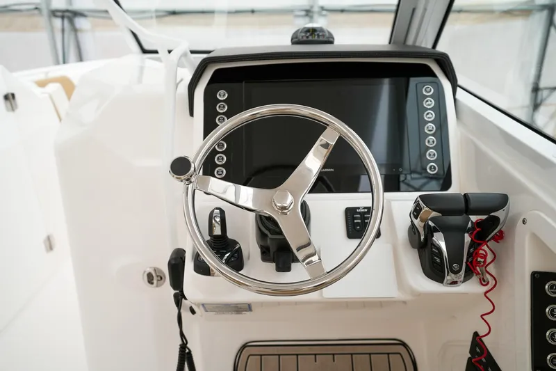  Yacht Photos Pics Edgewater 262 CX 2022 boat helm with steering wheel and control panel.