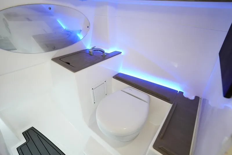  Yacht Photos Pics 2022 Edgewater 262 CX boat interior with modern bathroom and blue LED lighting.