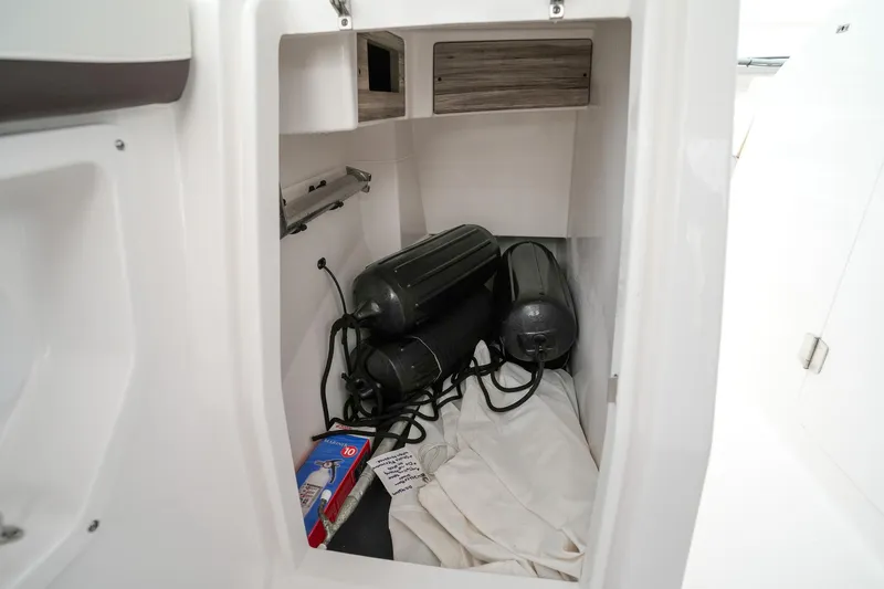  Yacht Photos Pics Storage compartment in 2022 Edgewater 262 CX boat with fenders and supplies.