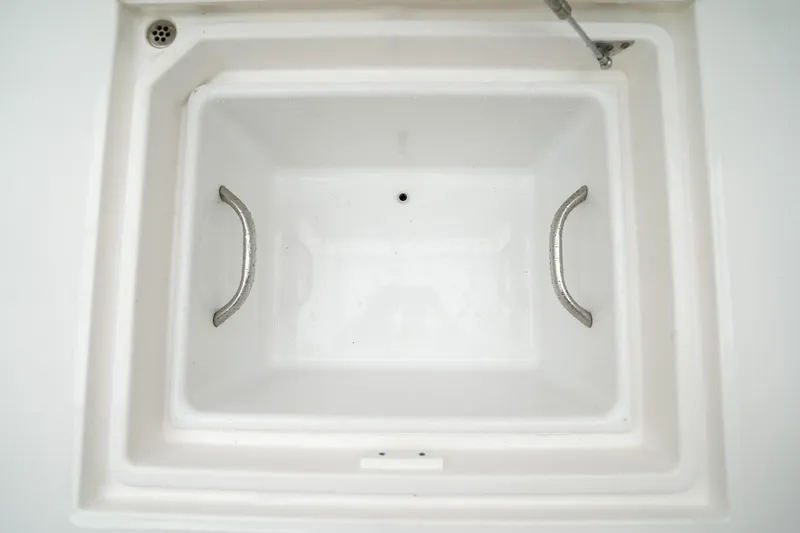  Yacht Photos Pics 2022 Edgewater 262 CX boat storage compartment with stainless steel handles.