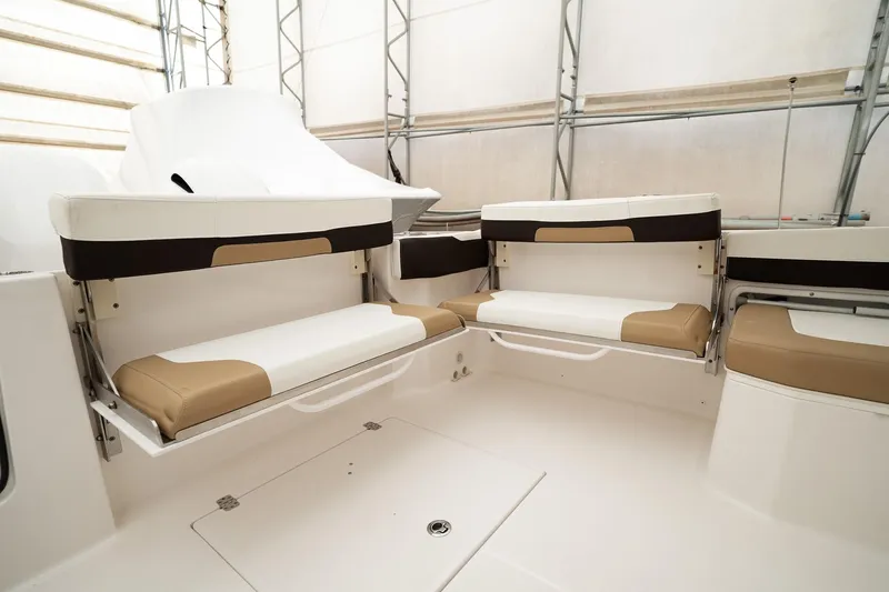  Yacht Photos Pics 2022 Edgewater 262 CX boat interior with cushioned seating in a spacious layout.