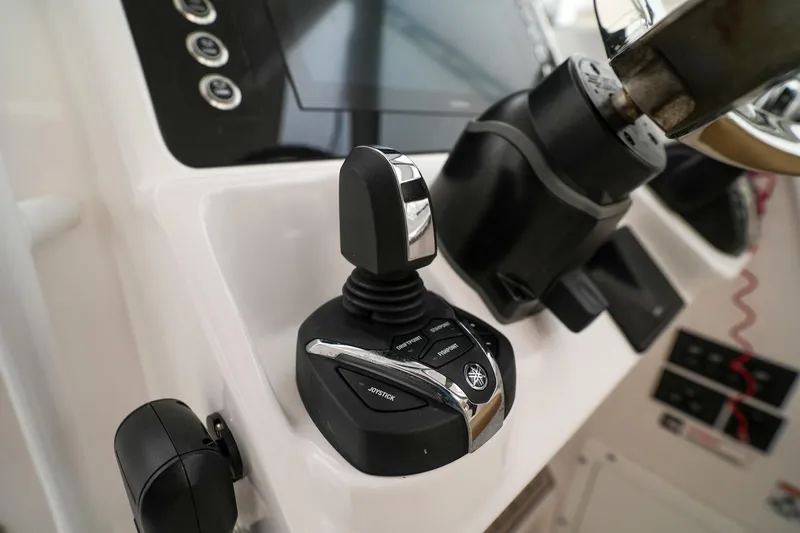  Yacht Photos Pics Close-up of 2022 Edgewater 262 CX boat controls and steering wheel.