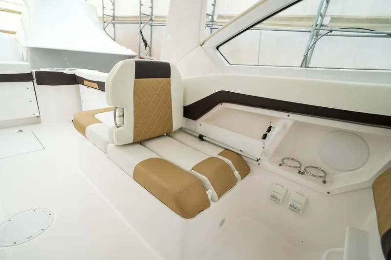  Yacht Photos Pics 2022 Edgewater 262 CX boat interior with tan and white seating, modern design.