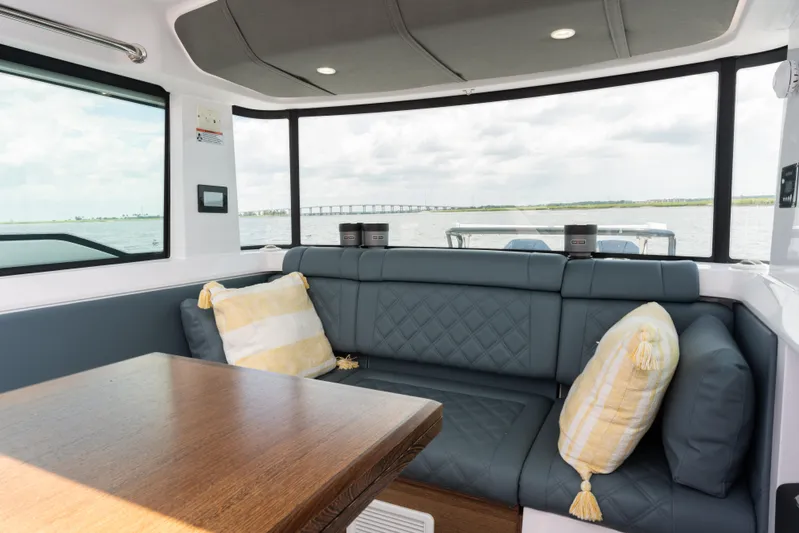  Yacht Photos Pics Interior of 2023 Axopar 37XC CROSS CABIN with plush seating and scenic window view.