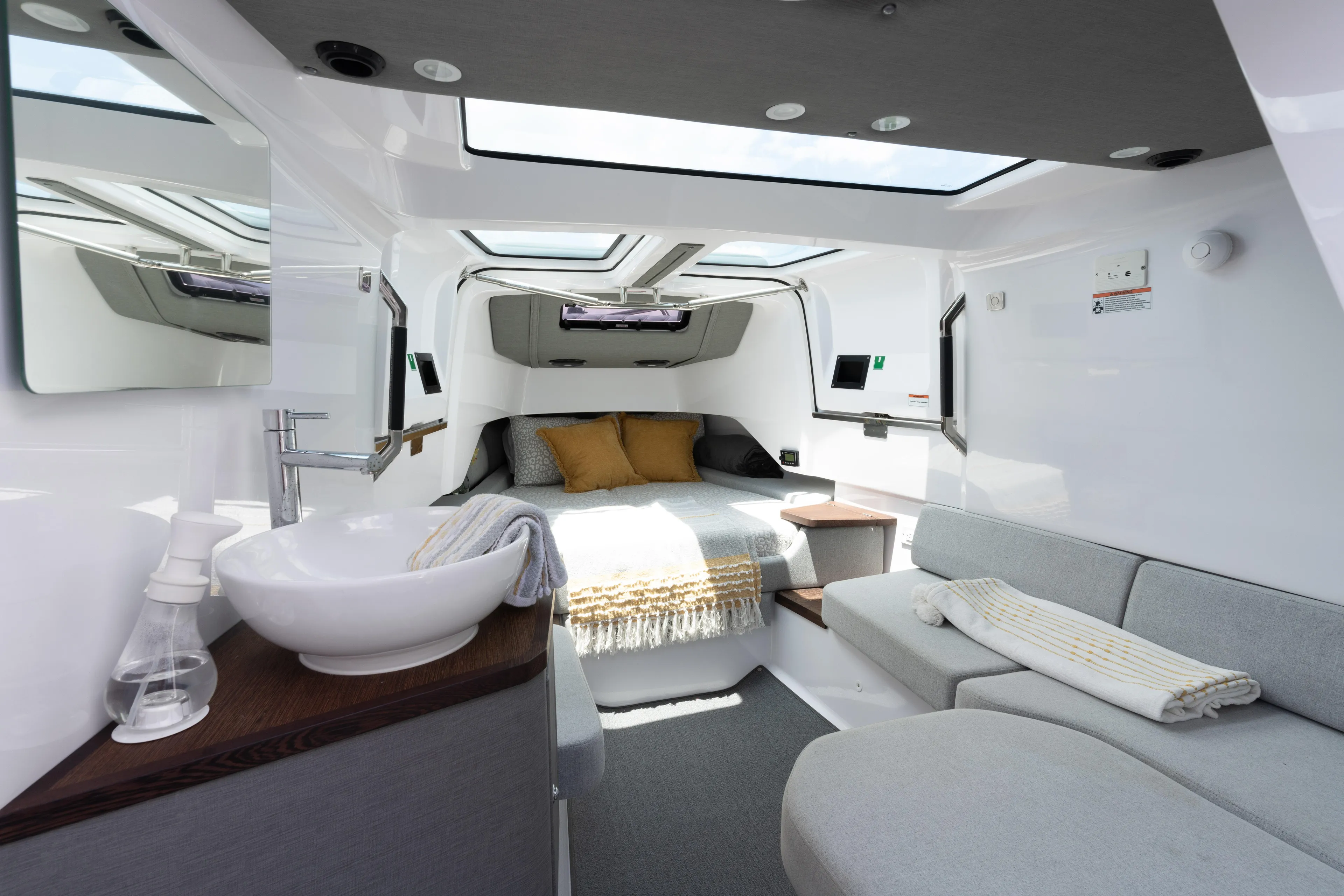 Yacht Photos Pics Luxurious interior of 2023 Axopar 37XC CROSS CABIN with modern amenities and cozy bedding.
