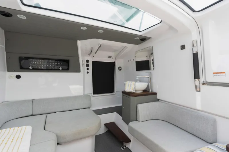  Yacht Photos Pics 2023 Axopar 37XC CROSS CABIN interior with modern seating and skylight.