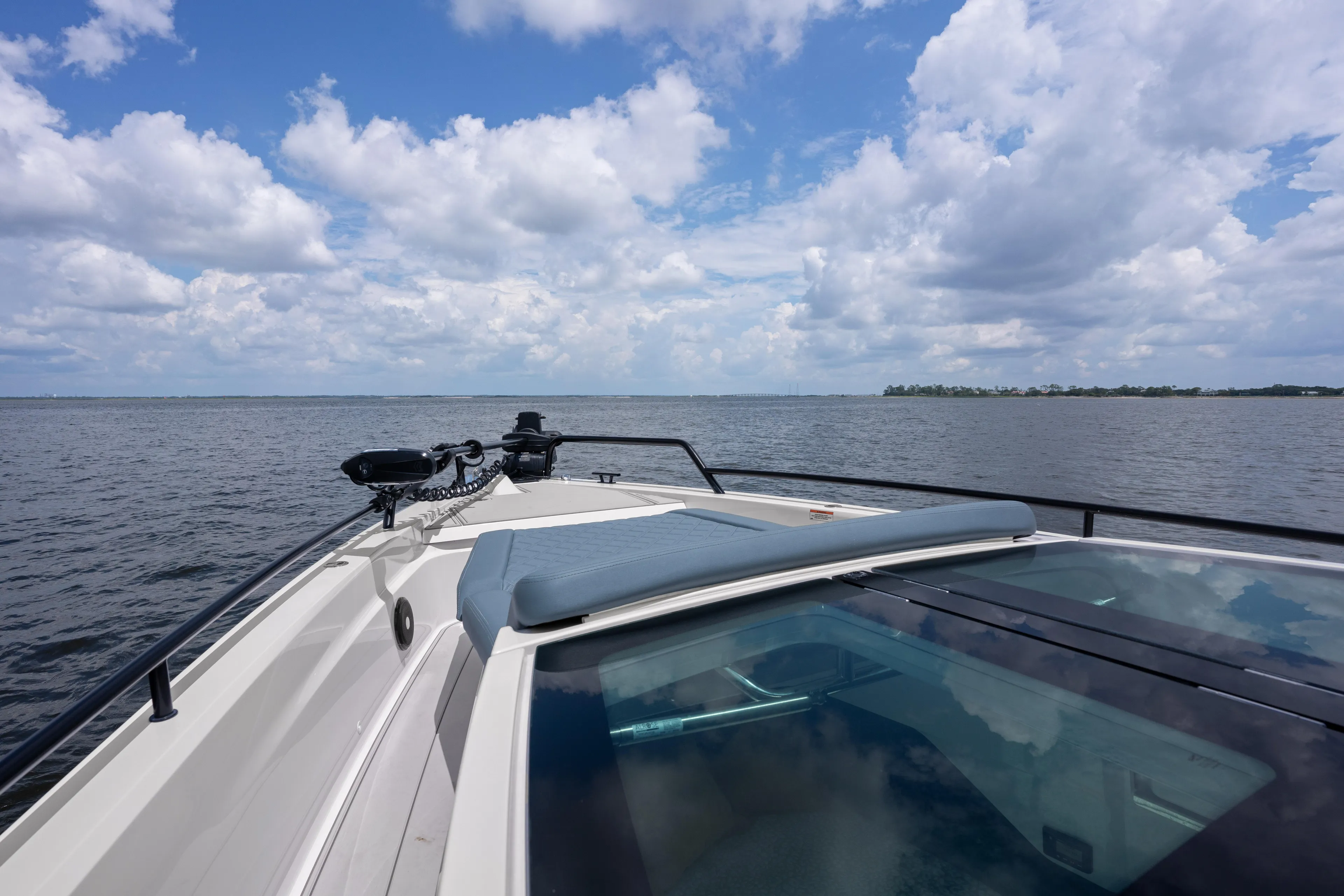  Yacht Photos Pics 2023 Axopar 37XC CROSS CABIN cruising on open water under a cloudy sky.