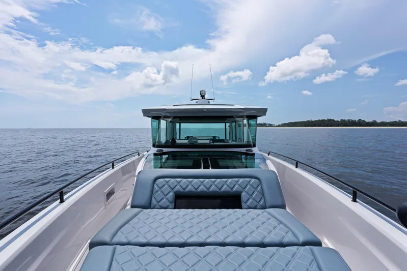  Yacht Photos Pics 2023 Axopar 37XC CROSS CABIN on open water, featuring sleek design and spacious seating.