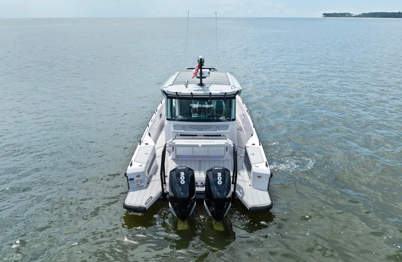  Yacht Photos Pics 2023 Axopar 37XC CROSS CABIN boat on open water, rear view.