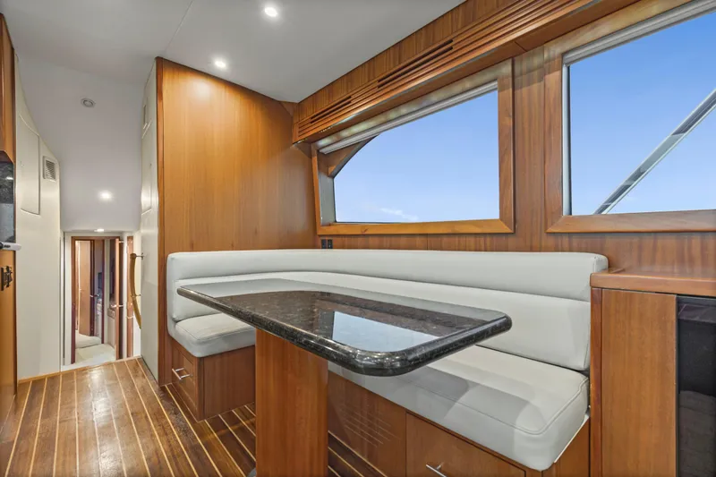 Blacksmith Yacht Photos Pics Luxurious interior of 2008 Hatteras 60 Convertible yacht with wood paneling and plush seating.