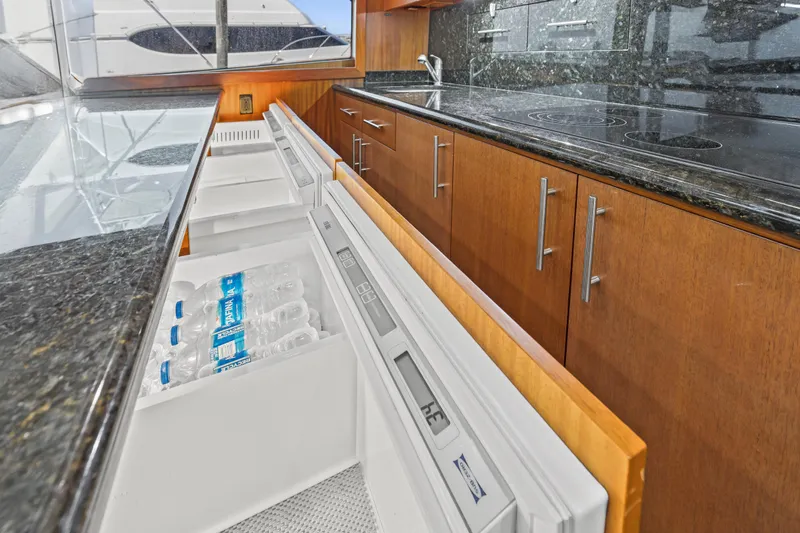 Blacksmith Yacht Photos Pics 2008 Hatteras 60 Convertible yacht kitchen with granite countertops and open refrigerator drawer.