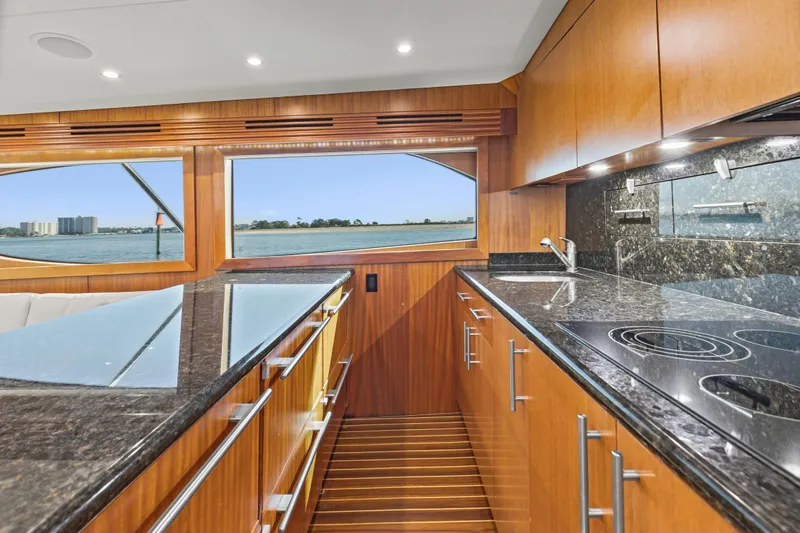 Blacksmith Yacht Photos Pics Luxurious kitchen interior of 2008 Hatteras 60 Convertible yacht with ocean view.