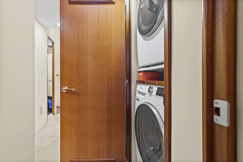 Blacksmith Yacht Photos Pics Laundry area with stacked washer and dryer inside 2008 Hatteras 60 Convertible yacht.