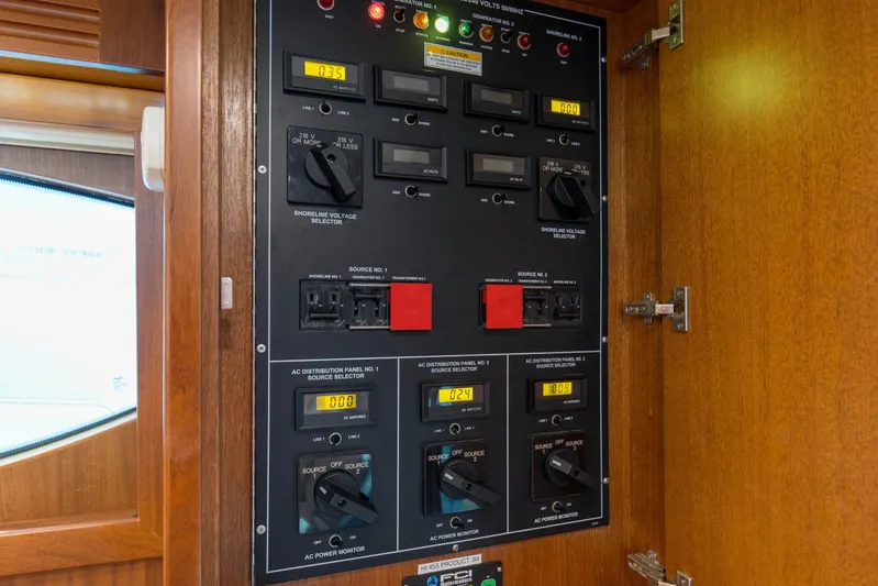 Blacksmith Yacht Photos Pics Electrical control panel inside 2008 Hatteras 60 Convertible yacht, featuring various switches and displays.