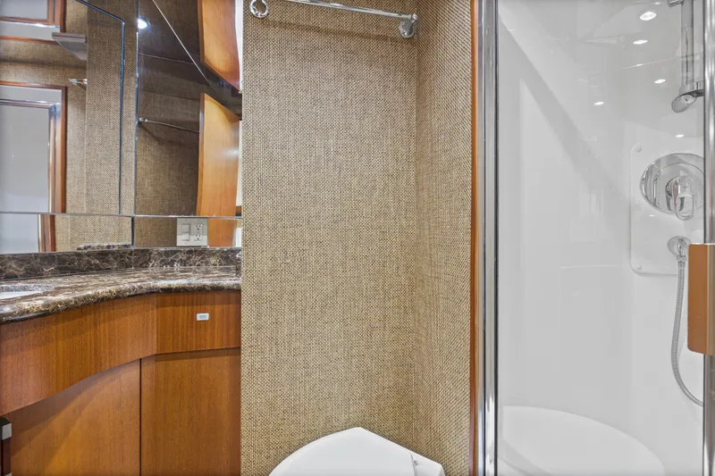 Blacksmith Yacht Photos Pics Luxurious bathroom interior of 2008 Hatteras 60 Convertible yacht with marble countertop.