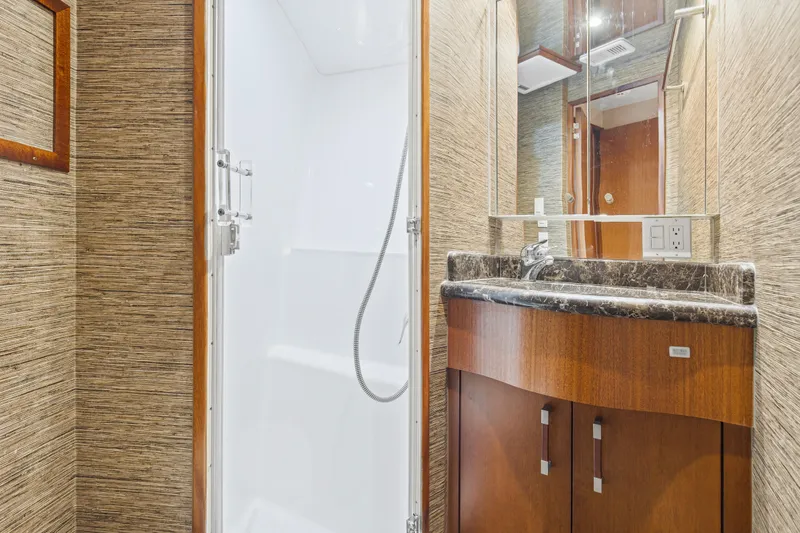 Blacksmith Yacht Photos Pics Luxurious bathroom in 2008 Hatteras 60 Convertible yacht with marble countertop and shower.