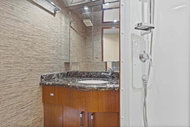 Blacksmith Yacht Photos Pics Luxurious bathroom in 2008 Hatteras 60 Convertible yacht with marble countertop and modern shower.