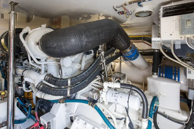 Blacksmith Yacht Photos Pics Engine room of 2008 Hatteras 60 Convertible yacht, showcasing complex machinery and piping.