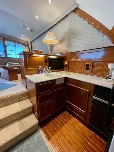 Murphy's Law Yacht Photos Pics Luxurious 1997 Post 50 Convertible yacht interior with modern kitchen and cozy seating area.