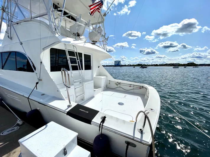 Murphy's Law Yacht Photos Pics 1997 Post 50 Convertible yacht docked by the water under a sunny sky.