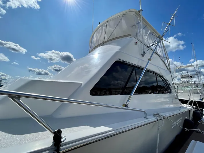 Murphy's Law Yacht Photos Pics 1997 Post 50 Convertible yacht under a bright blue sky with clouds.