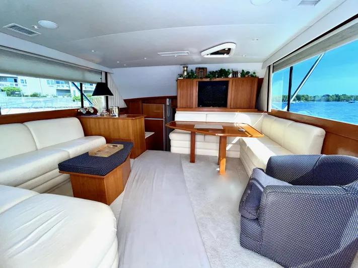 Murphy's Law Yacht Photos Pics Luxurious interior of a 1997 Post 50 Convertible yacht with elegant seating and panoramic windows.