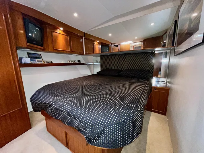 Murphy's Law Yacht Photos Pics Luxurious bedroom interior of a 1997 Post 50 Convertible yacht with wood cabinetry.