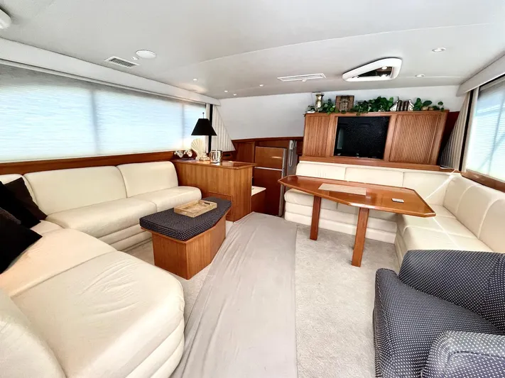 Murphy's Law Yacht Photos Pics Luxurious interior of a 1997 Post 50 Convertible yacht with elegant seating and wooden accents.