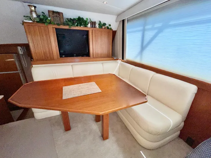 Murphy's Law Yacht Photos Pics Luxurious 1997 Post 50 Convertible yacht interior with elegant dining area and plush seating.