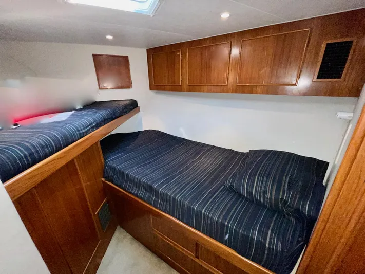 Murphy's Law Yacht Photos Pics Cozy cabin interior of a 1997 Post 50 Convertible yacht with wooden cabinets and twin beds.