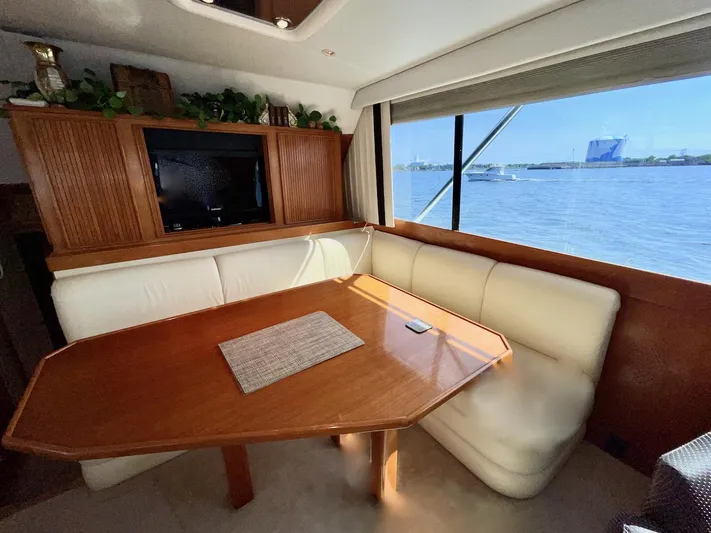 Murphy's Law Yacht Photos Pics Luxurious 1997 Post 50 Convertible yacht interior with dining area and scenic ocean view.