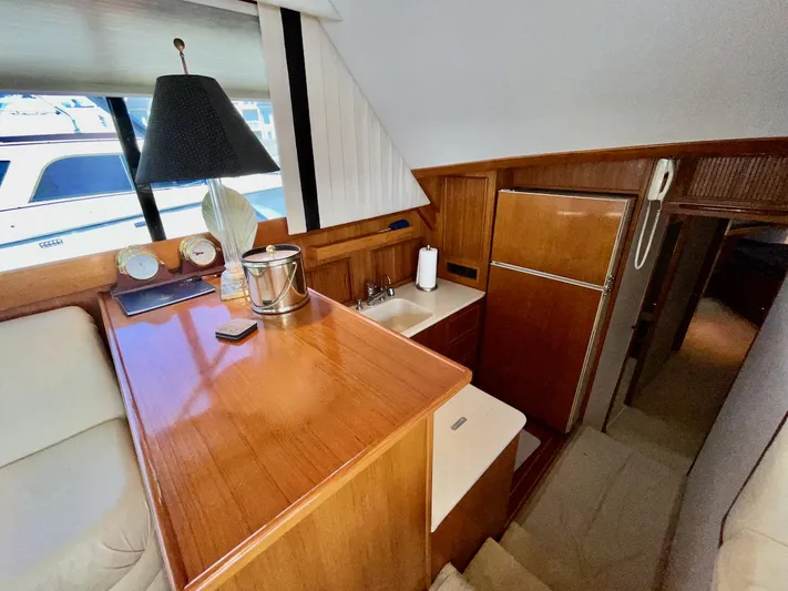 Murphy's Law Yacht Photos Pics Interior of a 1997 Post 50 Convertible yacht with wooden cabinetry and compact kitchen area.