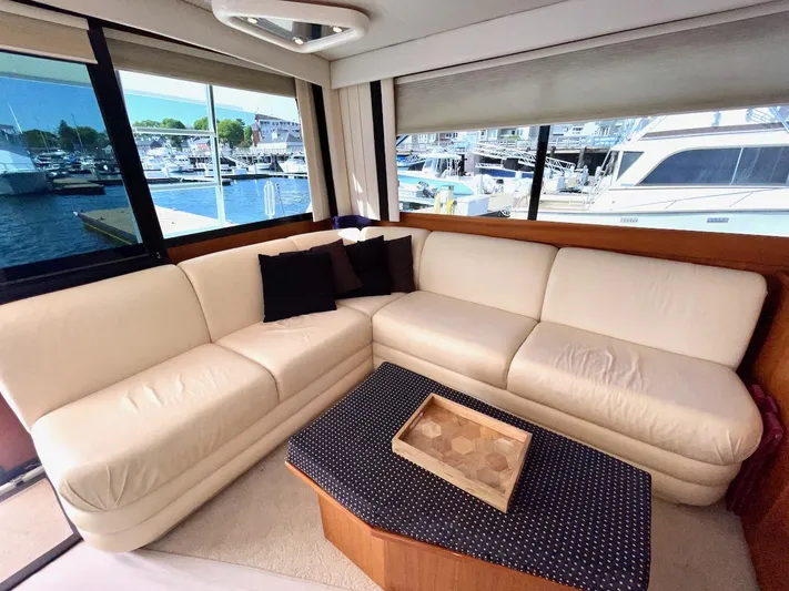 Murphy's Law Yacht Photos Pics Luxurious interior of a 1997 Post 50 Convertible yacht with cream leather seating.