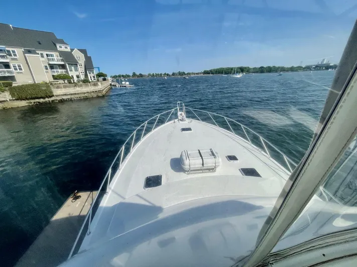 Murphy's Law Yacht Photos Pics 1997 Post 50 Convertible yacht on calm waters near residential area.