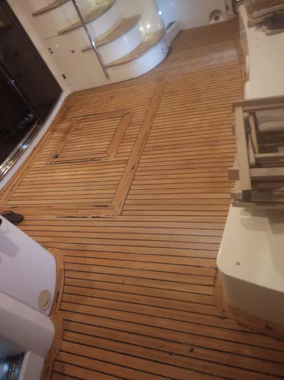 Capricho II Yacht Photos Pics Teak deck of a 2011 Sunseeker Manhattan 70 yacht with wooden flooring and steps.