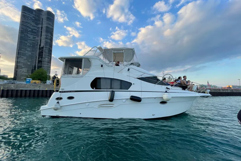  Yacht Photos Pics 2006 Silverton 35 Motor Yacht on water, city skyline in background.